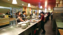 Students go through the campus dining hall line