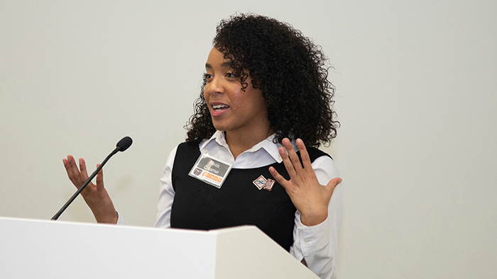 Alexis Creamer speaking at conference.