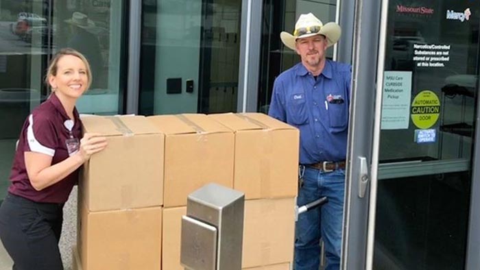 Jaime Gnau bringing in food box to MSU Care Clinic.