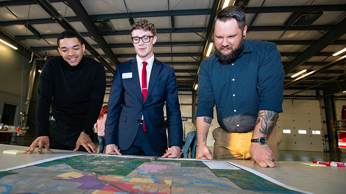 Brandon Jenson looking over Willard map with Missouri State planning students.