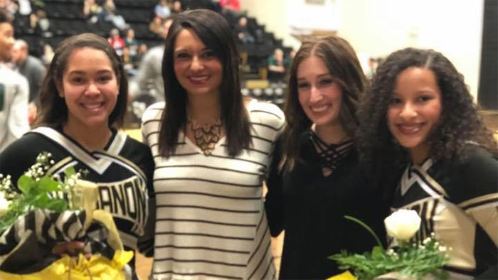 Justice Davis with assistant cheerleading coach and Lebanon High School cheerleaders.
